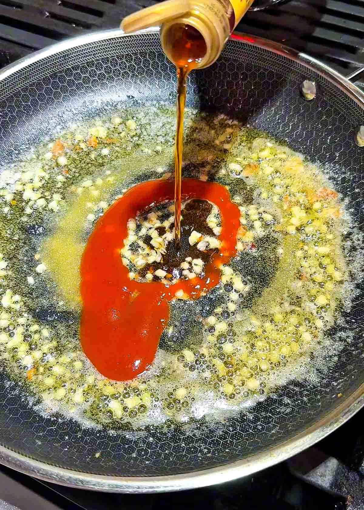 minced garlic cooking in butter in a pan for spicy glaze sauce