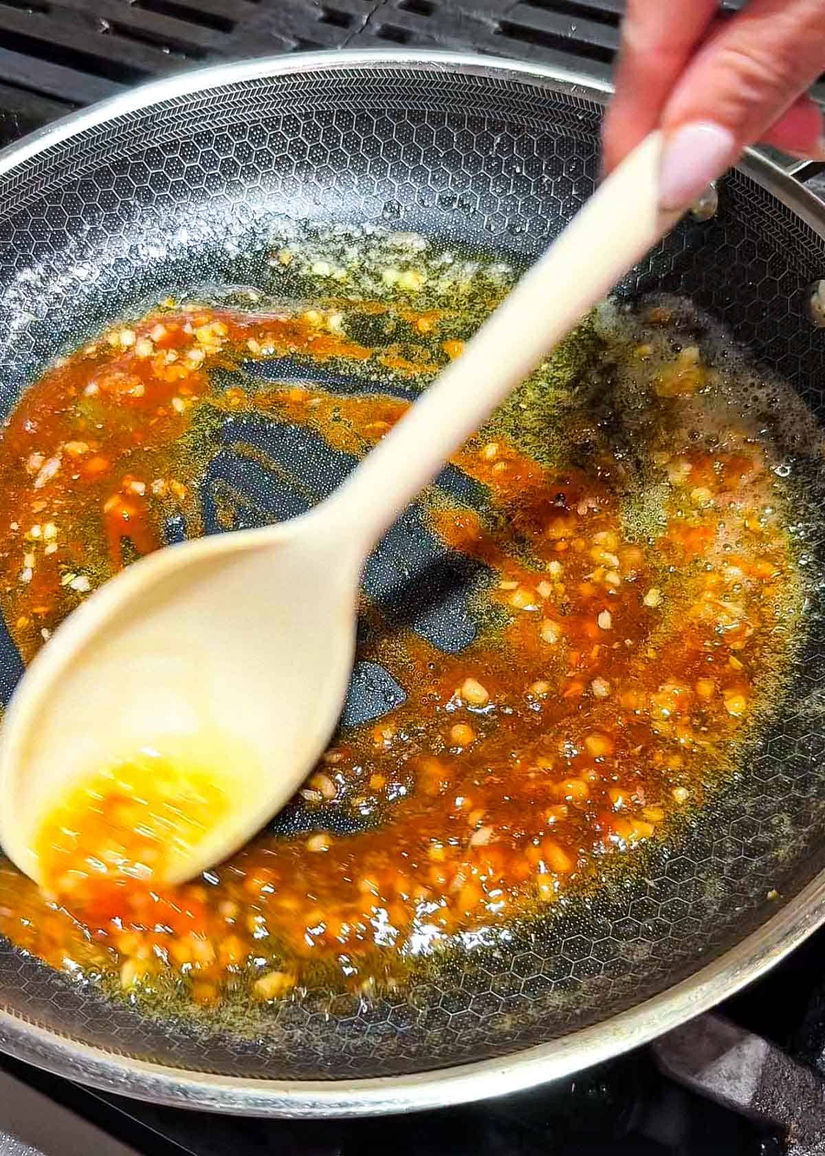 sweet spicy garlic lime sauce simmering in pan