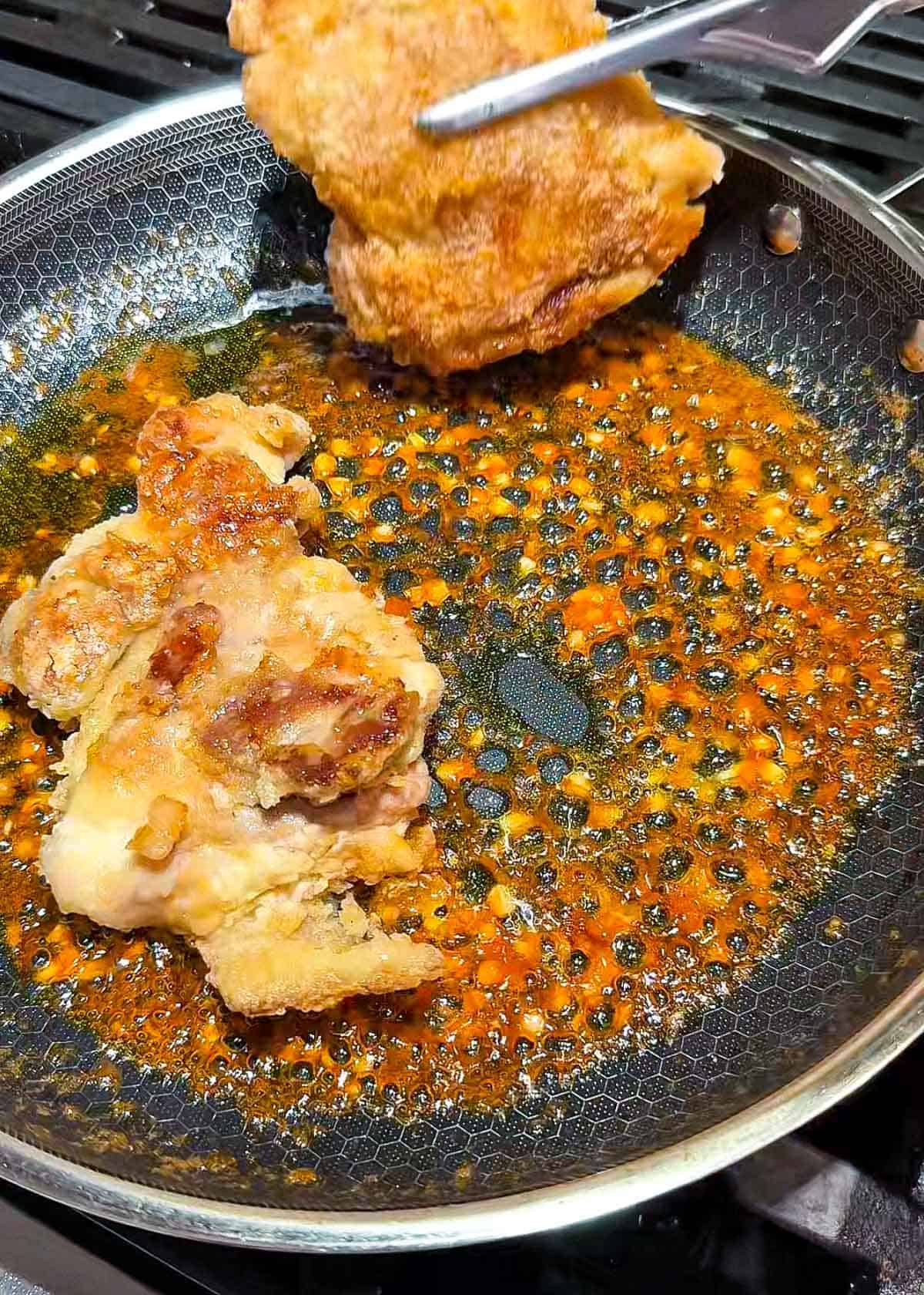 crispy chicken thigh pieces tossed in sticky spicy garlic sauce