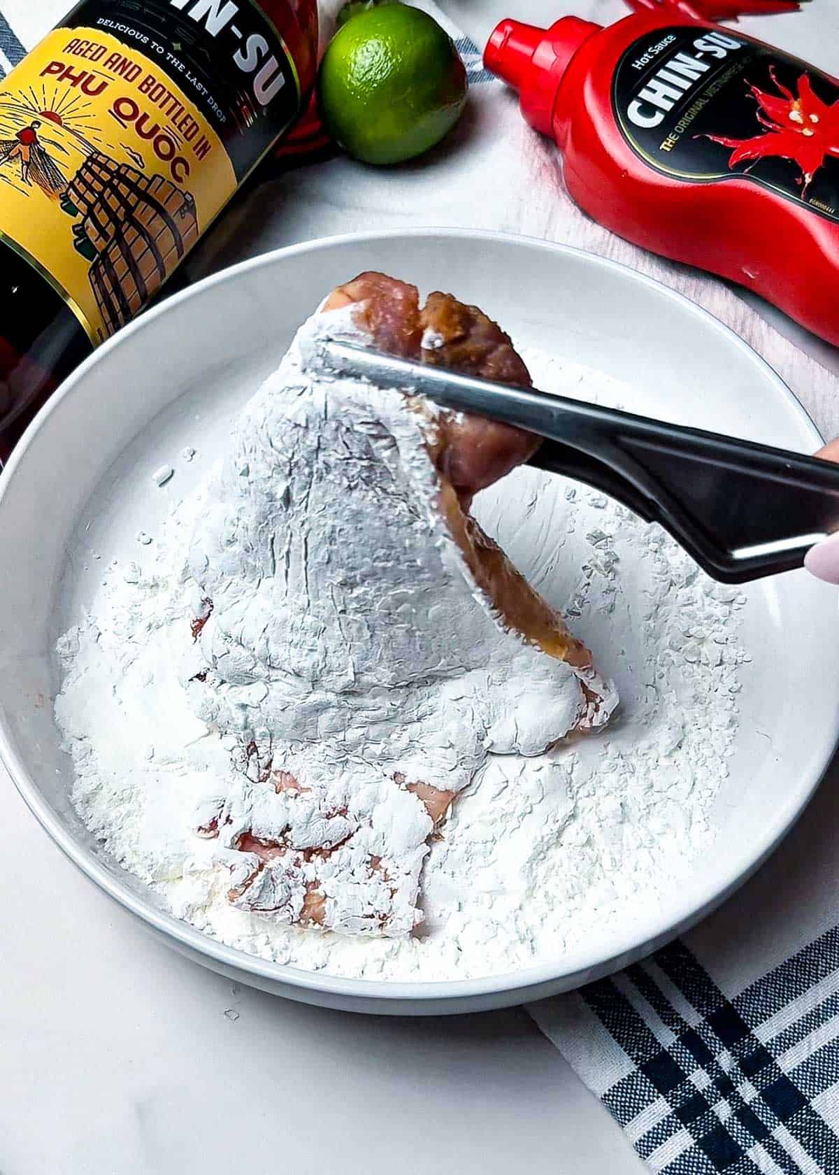 marinated chicken thigh pieces coated in cornstarch before frying