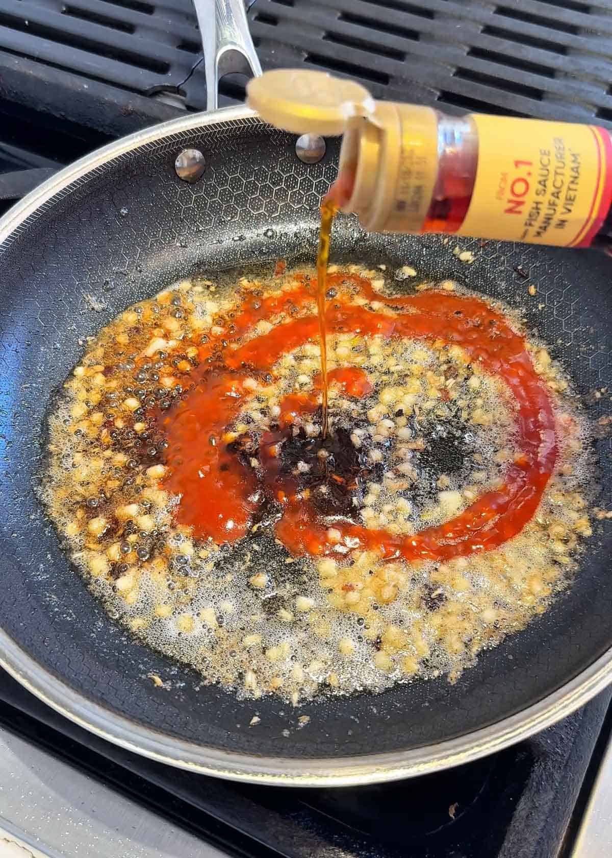 Garlic sugar hot sauce and butter simmering in a pan to make sauce