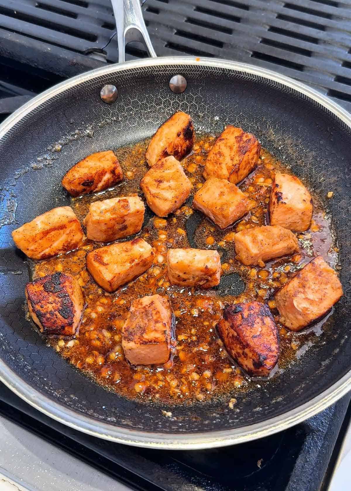 Cube salmon that's been browned in a pan with sticky sauce