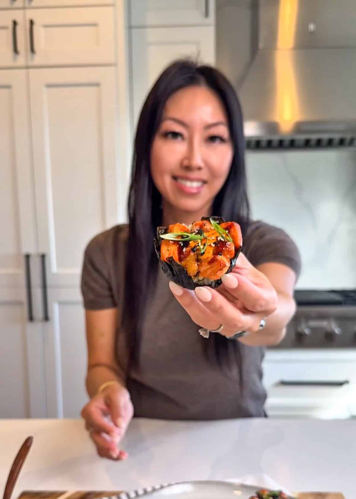 Sharon holding a sushi cup