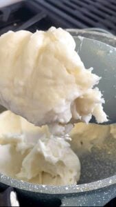 Thick rice flour batter on a spatula with a mashed potato texture