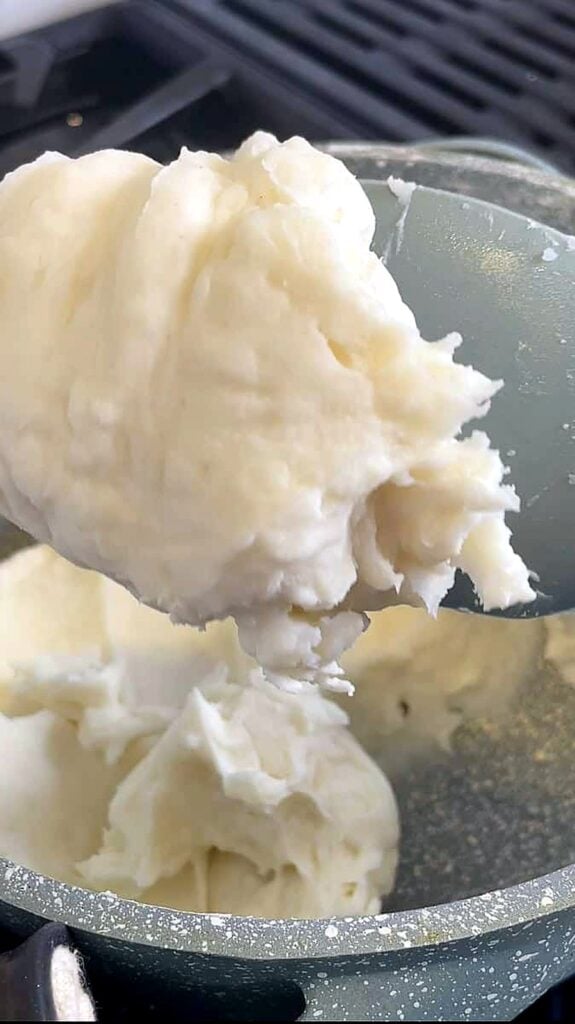 Thick rice flour batter on a spatula with a mashed potato texture